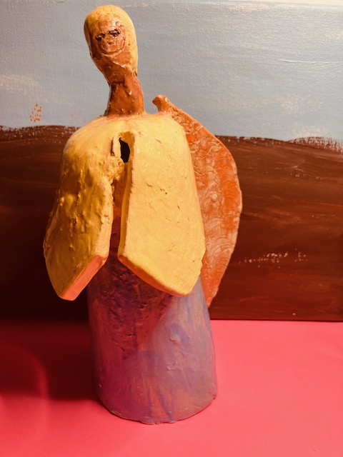 alt text = Clay angel with blue and yellow gown and orange wings